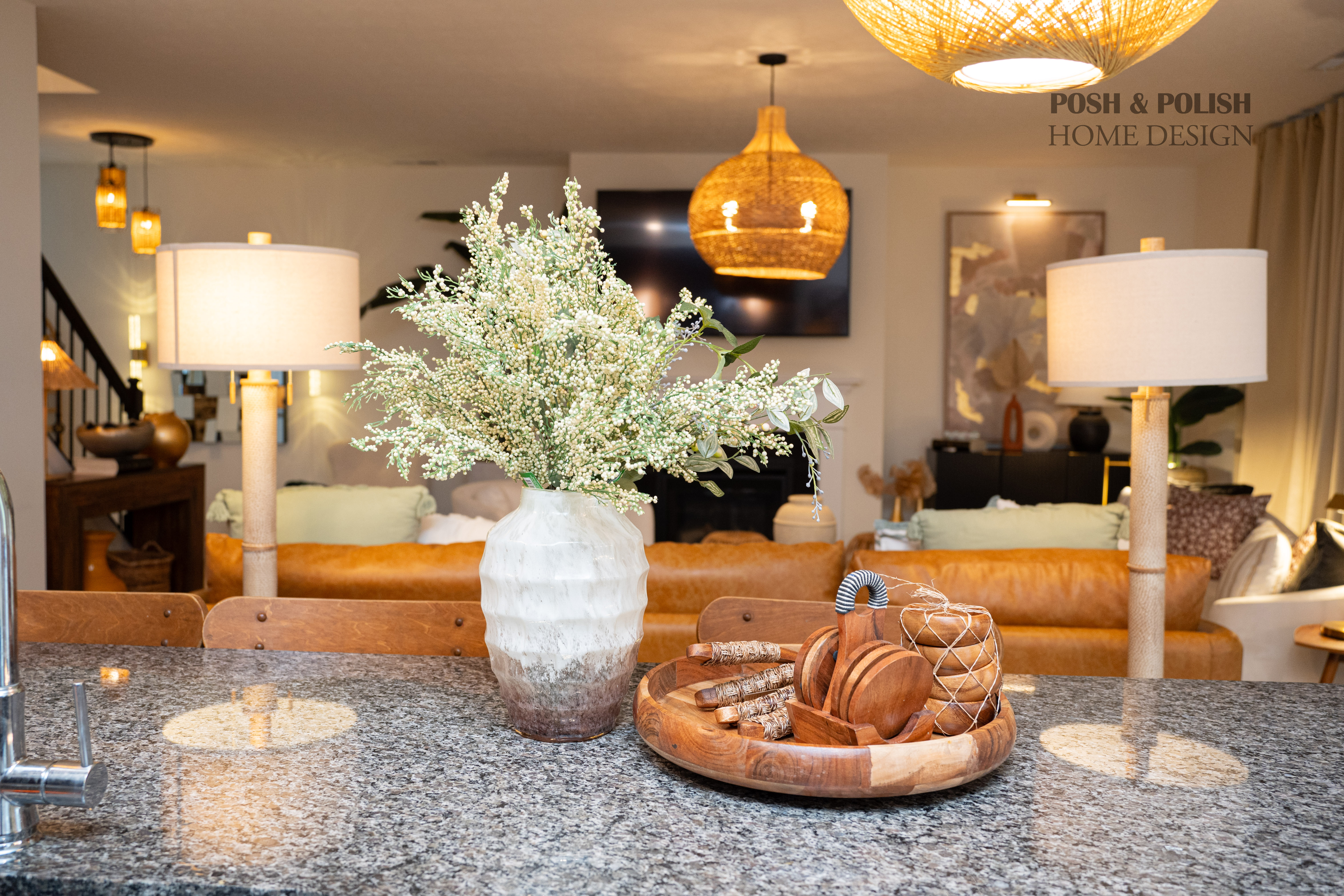 A sleek, modern kitchen with dark cabinetry, brass hardware, and a large central island, designed for both cooking and entertaining.